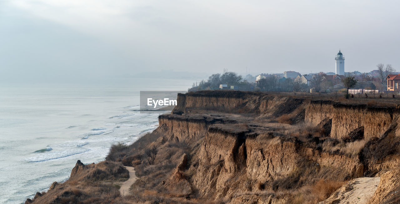 PANORAMIC VIEW OF ROCKS ON BEACH AGAINST SKY