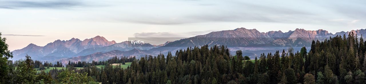 Scenic view of mountains against cloudy sky