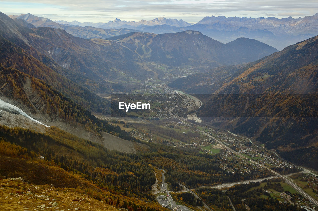 High angle view of land and mountains against sky