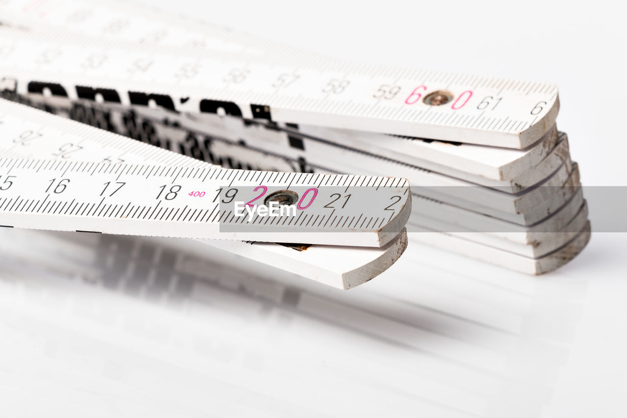 Close-up of wooden rulers on white background