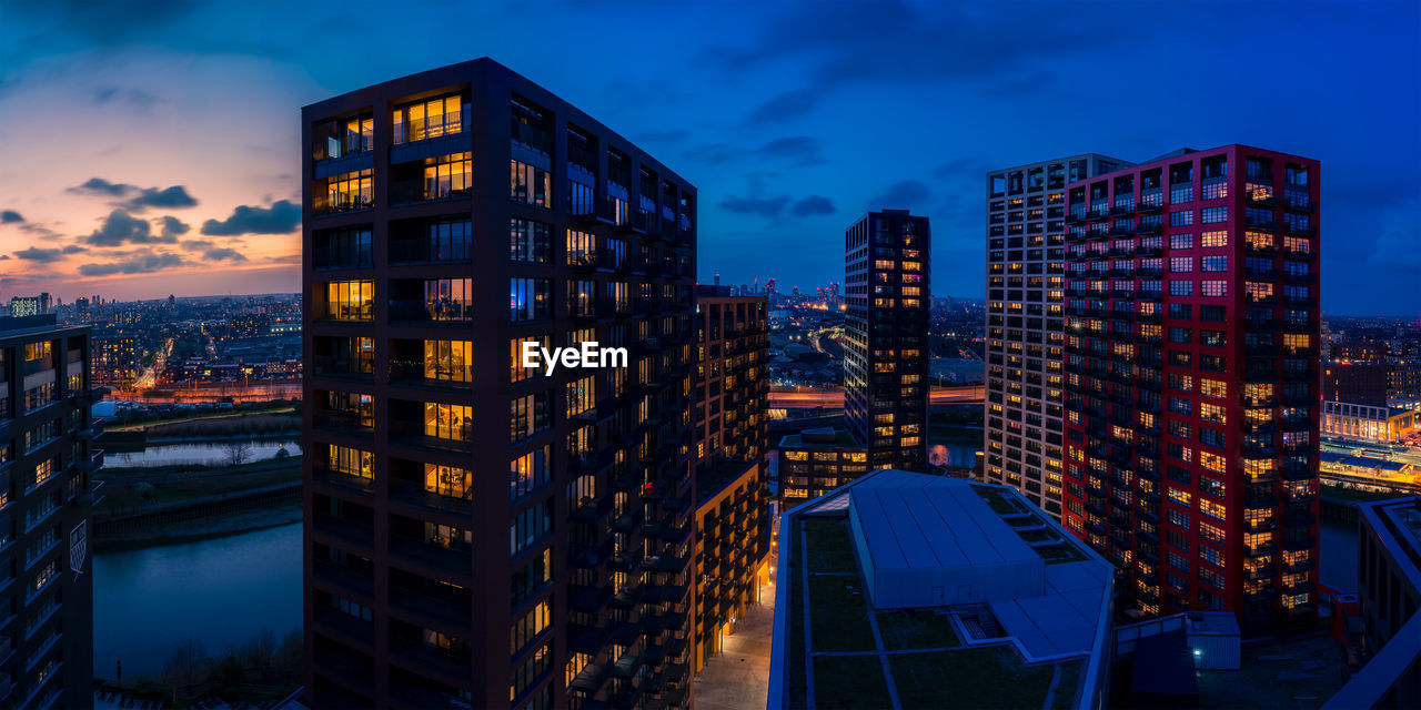 Illuminated buildings against sky at night