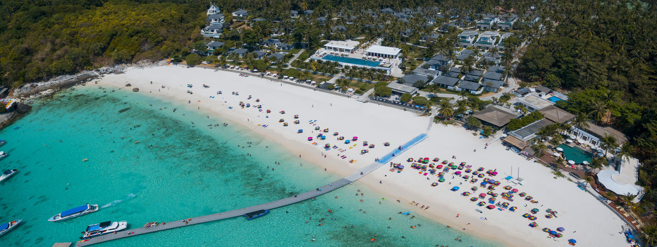 HIGH ANGLE VIEW OF PEOPLE SWIMMING POOL