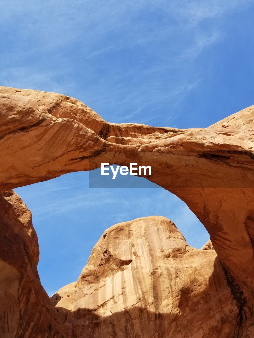 Low angle view of rock formations against blue sky