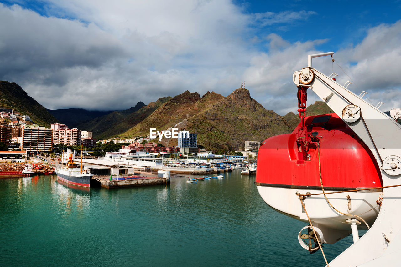 Lifeboat on cruise ship in sea against cloudy sky at canary islands