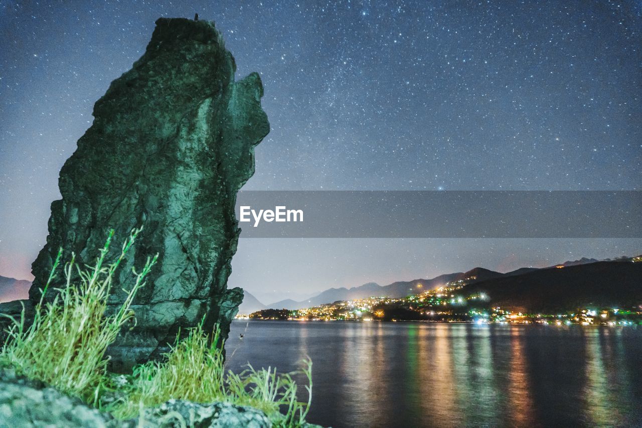 SCENIC VIEW OF ILLUMINATED MOUNTAIN AGAINST SKY