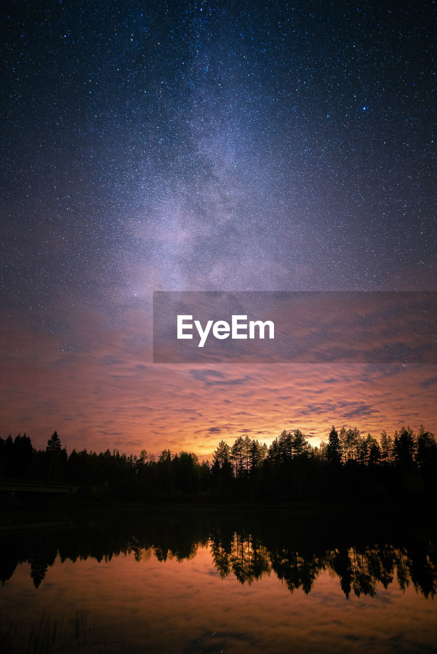 Scenic view of river against sky at night