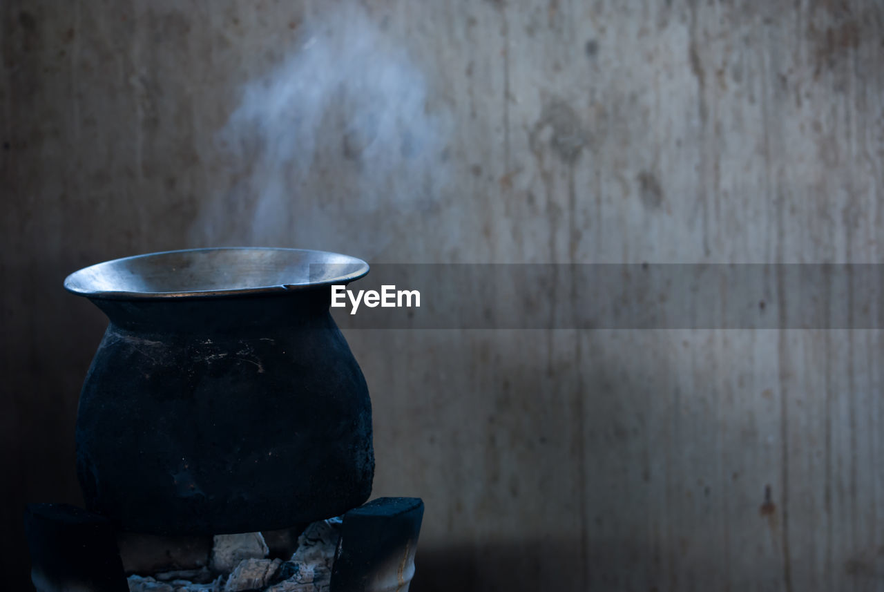 Close-up of food being cooked on stove against wall