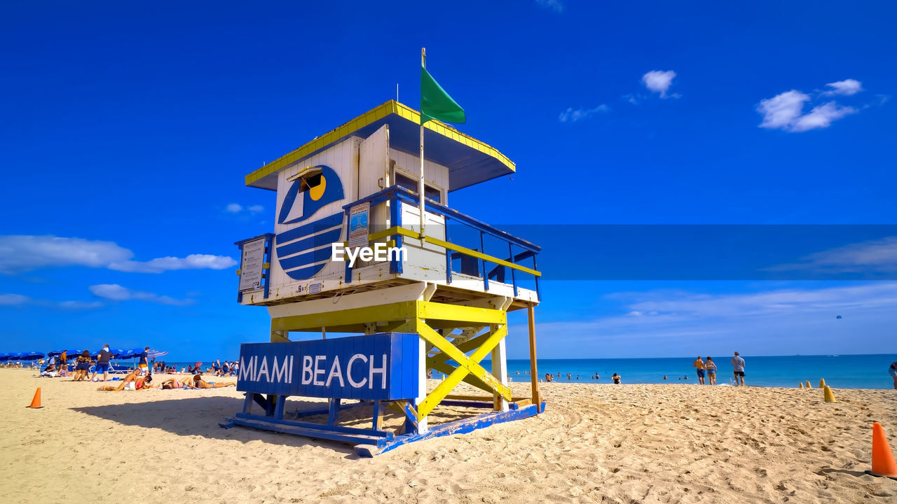 beach, land, sea, sky, sand, water, lifeguard hut, man made structure, hut, lifeguard, nature, vacation, architecture, trip, travel destinations, holiday, blue, horizon over water, protection, security, horizon, travel, cloud, summer, built structure, tourism, scenics - nature, beauty in nature, building exterior, tower, coastline, tranquility, outdoors, ocean, sunny, day, sunlight, tranquil scene, coast, building, water's edge, chair, no people