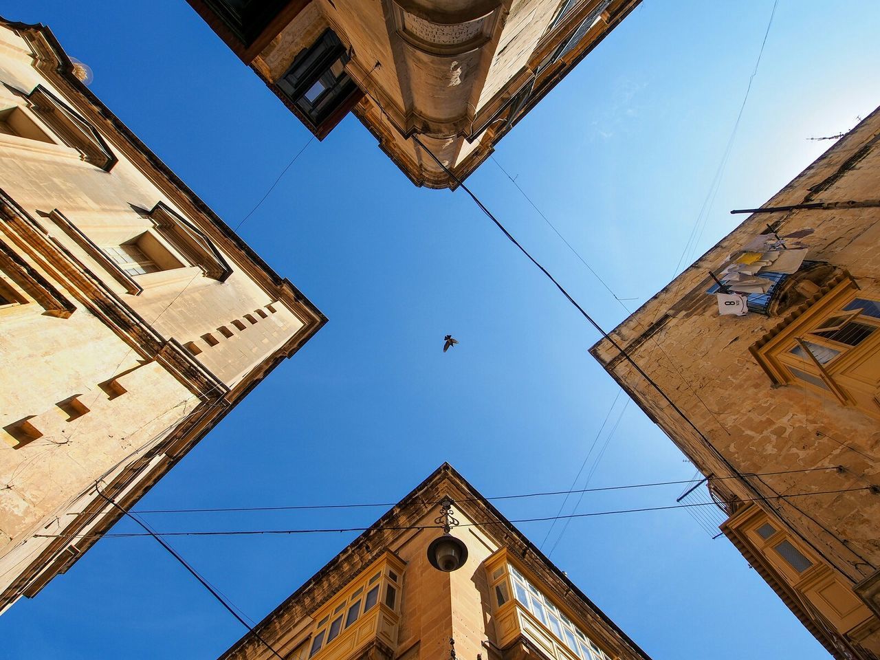 Directly below shot of buildings against sky