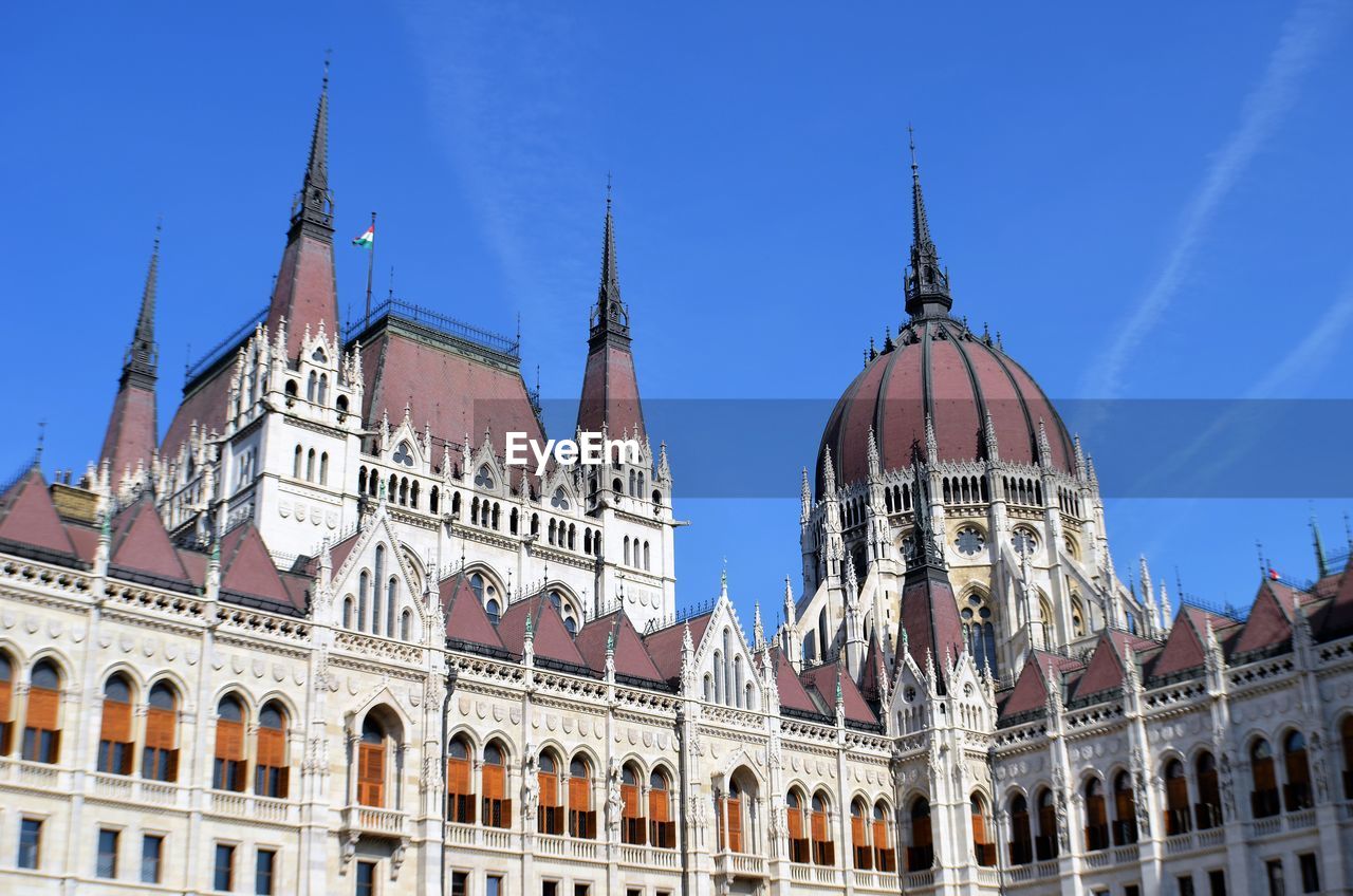 Low angle view of buildings against blue sky