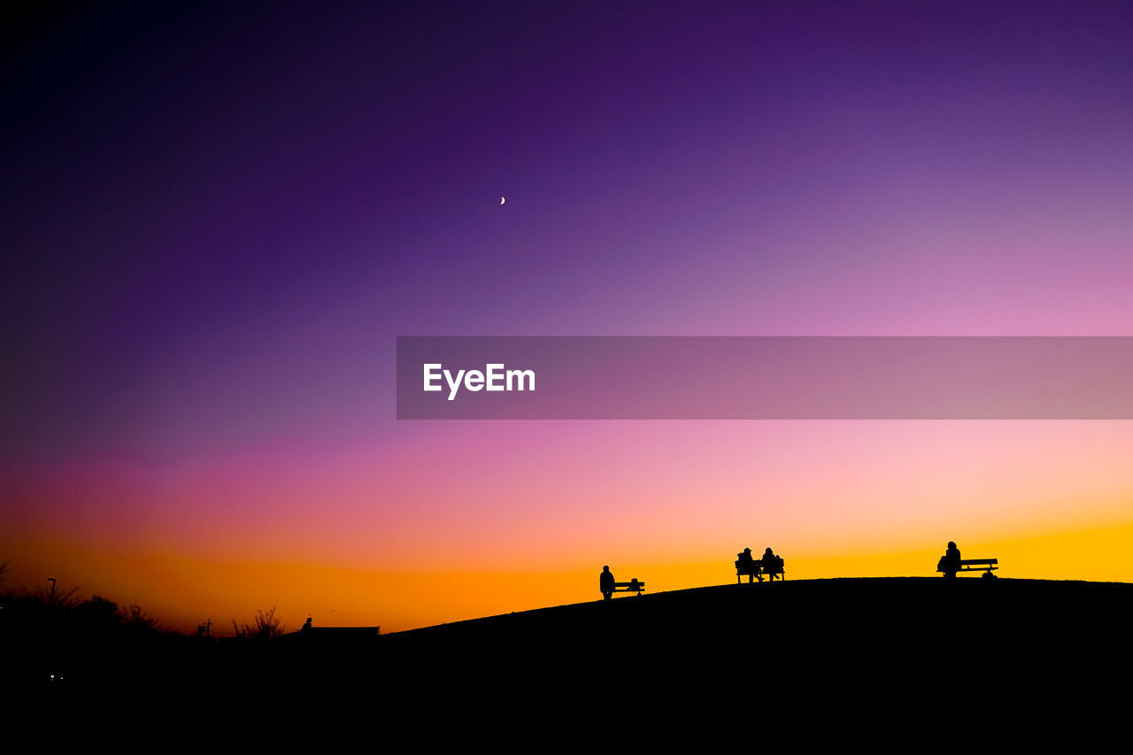 silhouette, sky, horizon, sunset, dawn, nature, group of people, scenics - nature, beauty in nature, afterglow, orange color, landscape, astronomical object, sun, tranquility, land, leisure activity, tranquil scene, moon, environment, copy space, outdoors, travel, men, evening, travel destinations, lifestyles, animal, animal themes