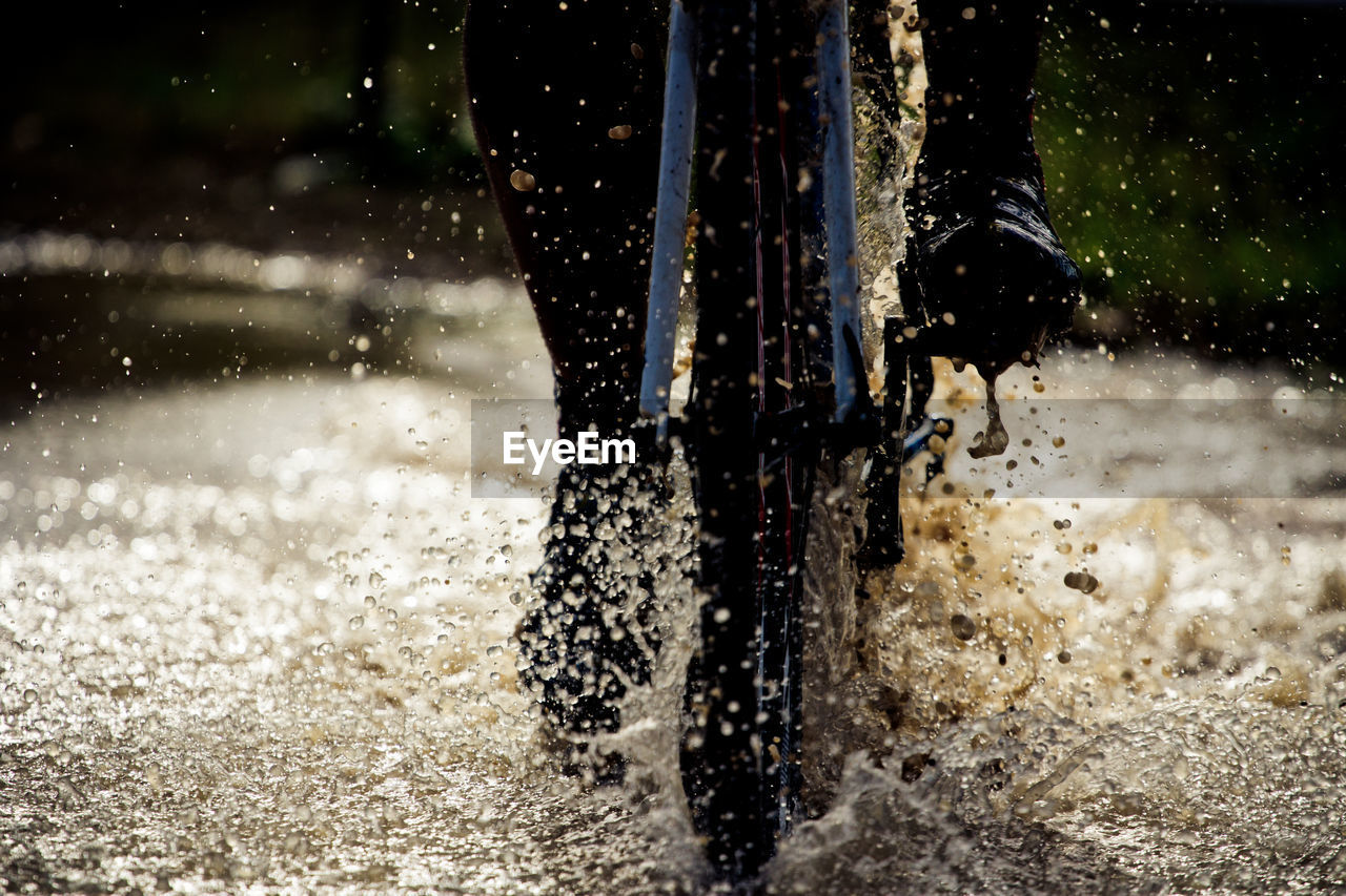 Cropped image of person cycling in water