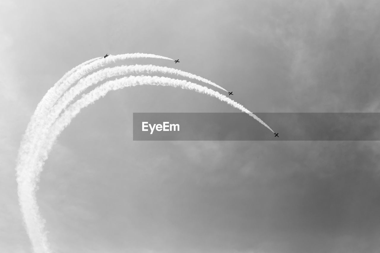 Low angle view of airshow against sky