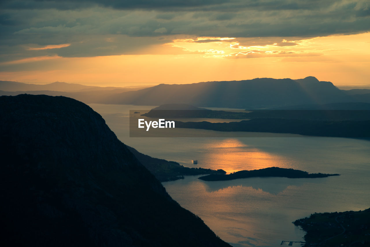 Scenic view of silhouette mountains against sky during sunset