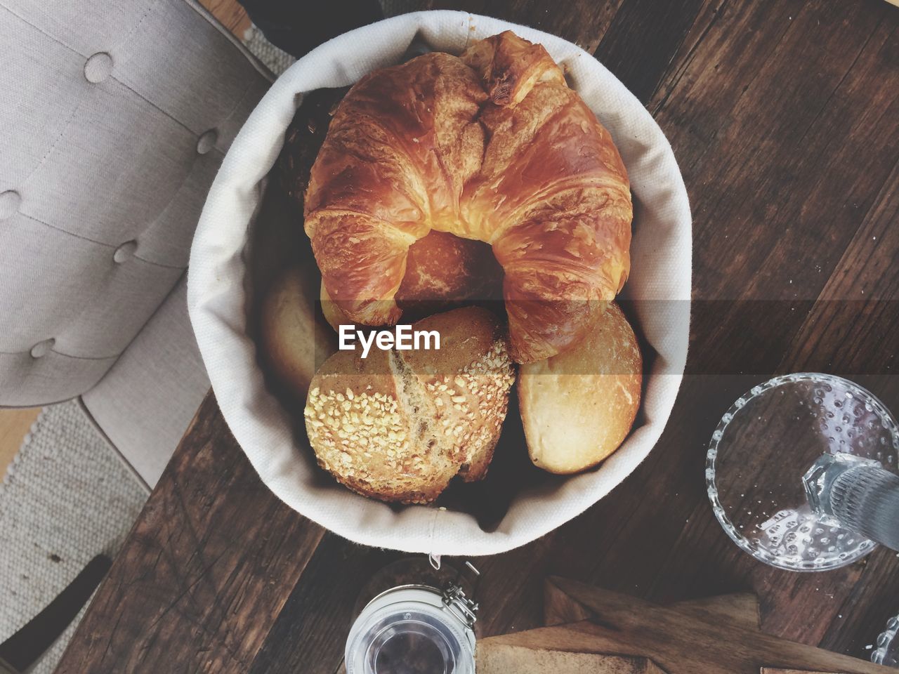 Directly above shot of fresh breads in bowl on table