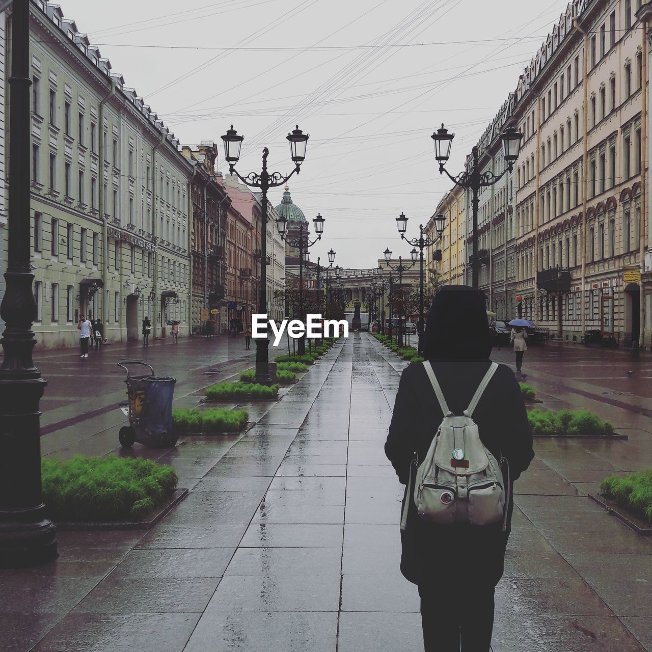 Rear view of woman walking on street in city