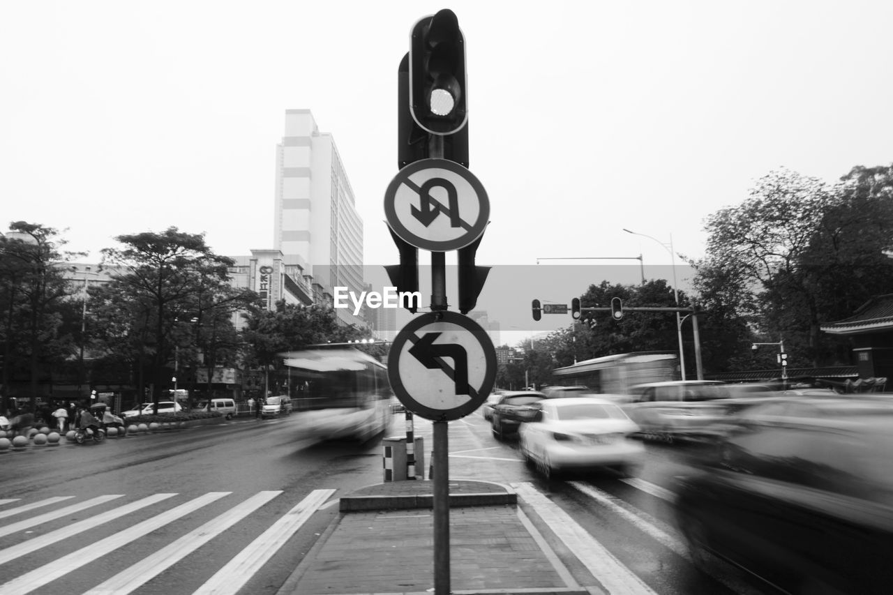 Cars moving on road against sky