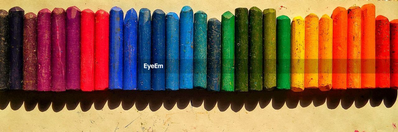 Panoramic shot of colorful crayons on table