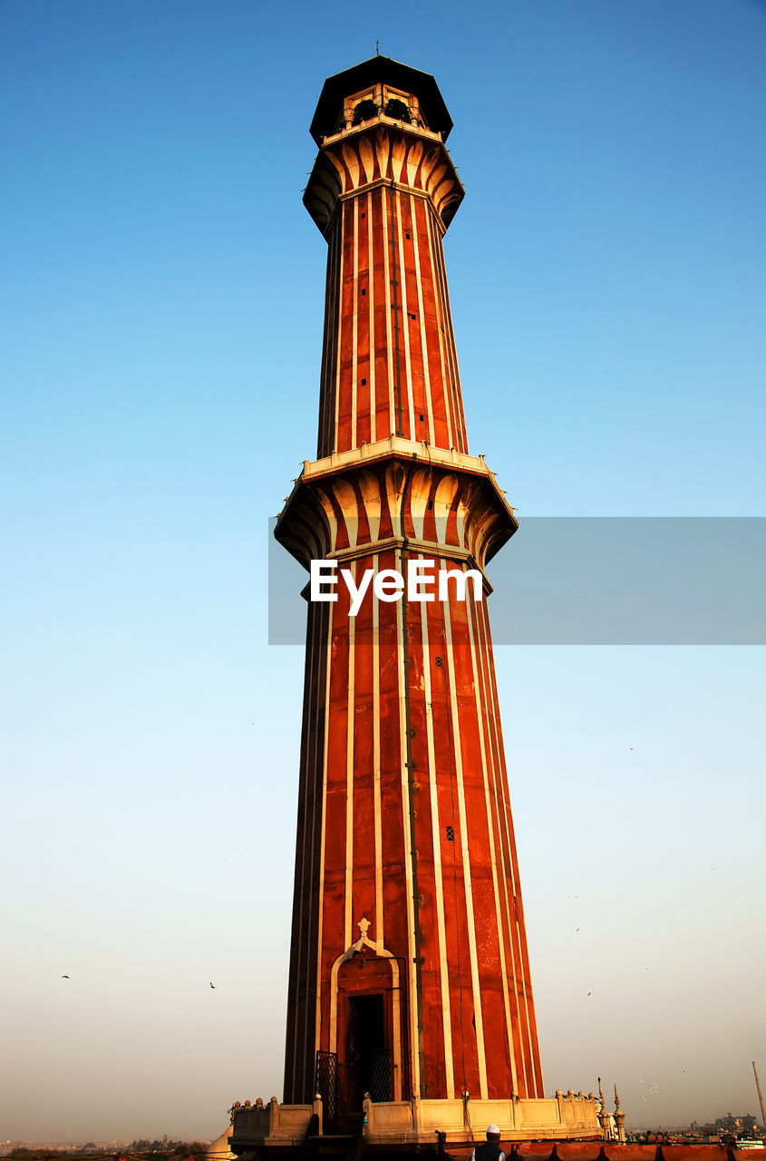 Low angle view of jami masjid minaret against clear sky