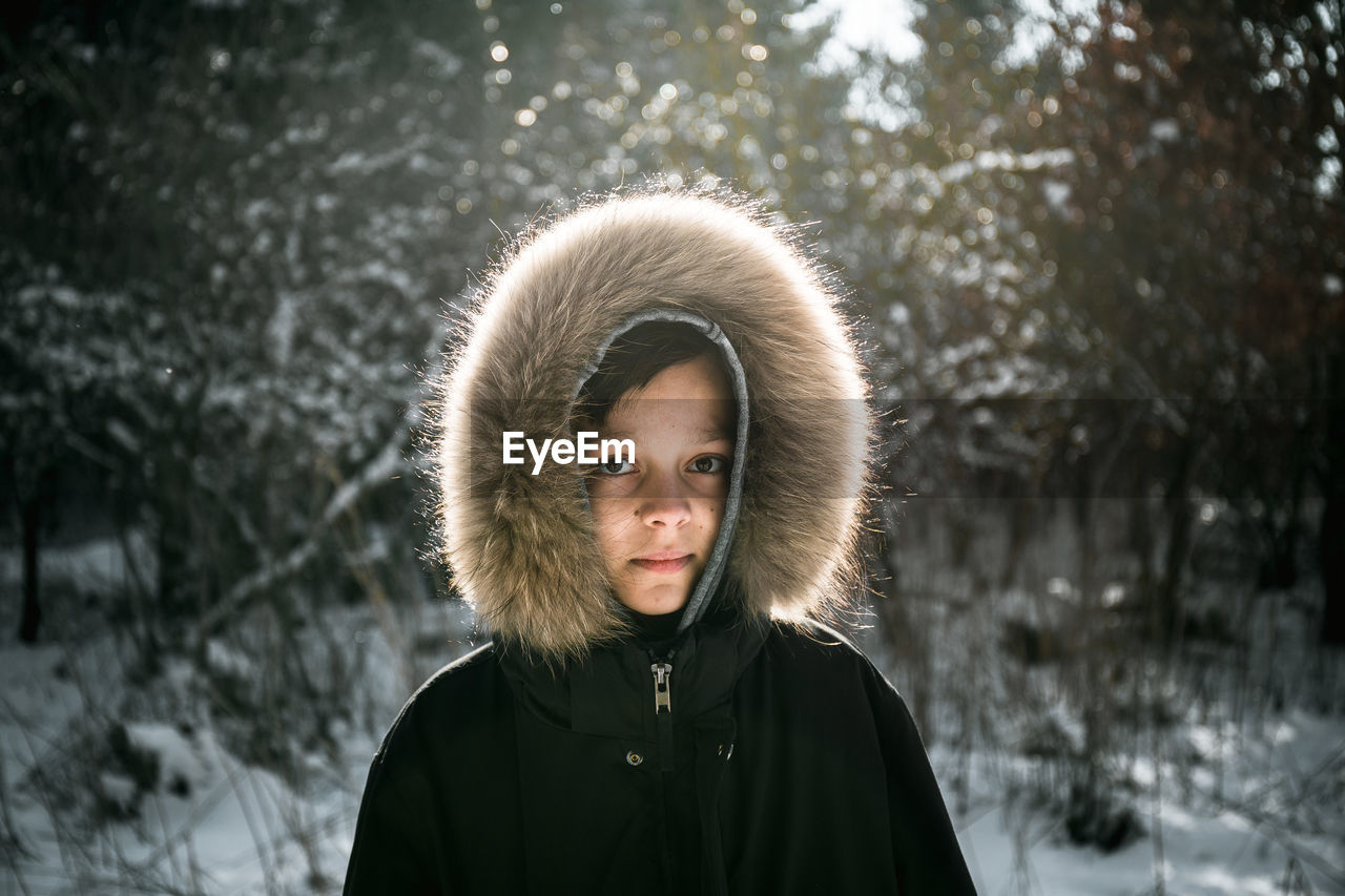 Portrait of boy wearing fur coat