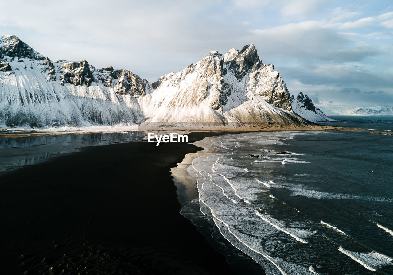 Scenic view of lake against sky during winter