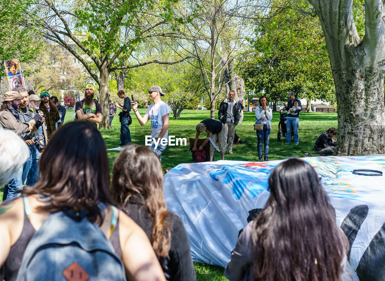 People around project displayed in park