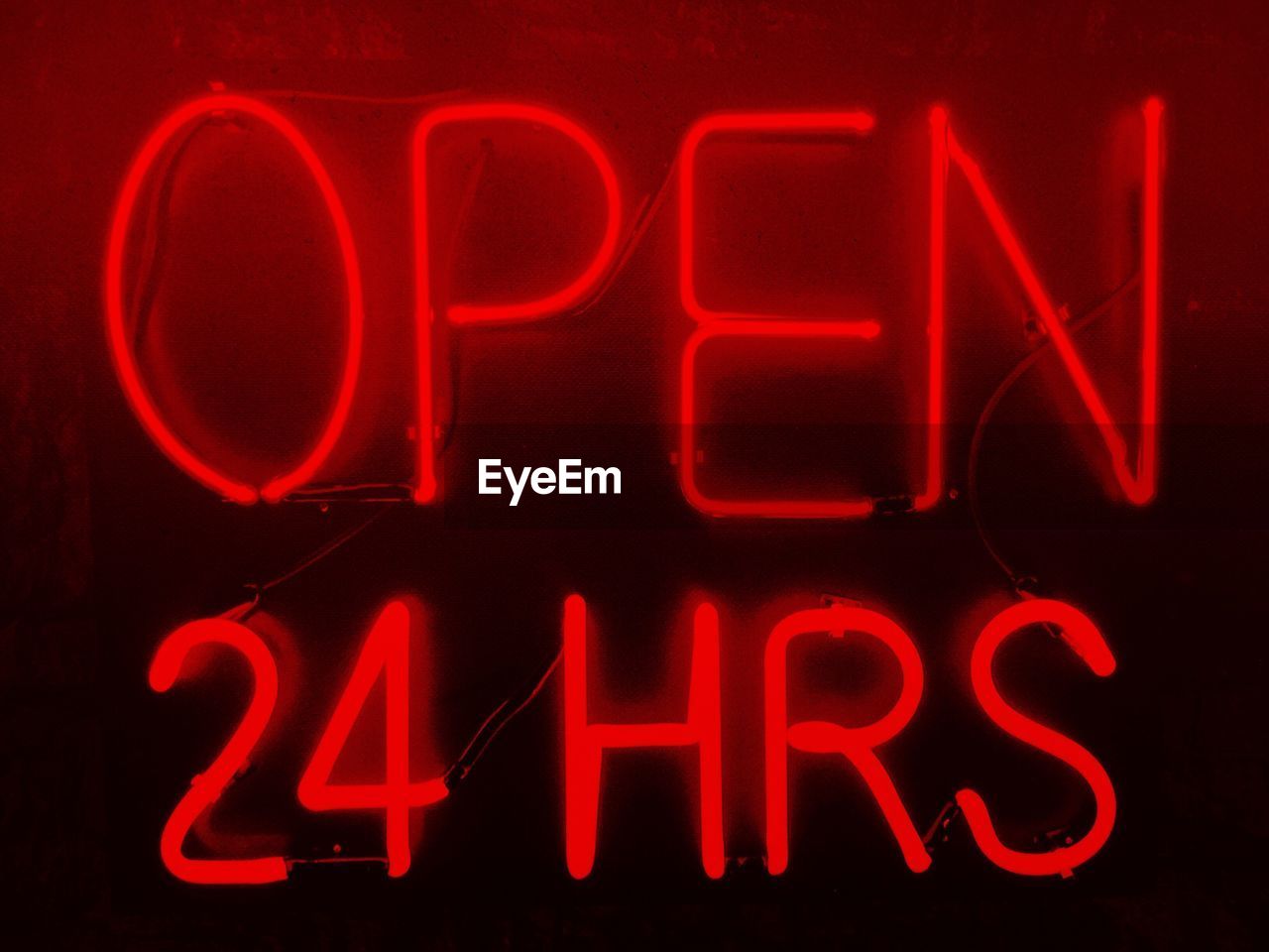 Illuminated open sign on store at night