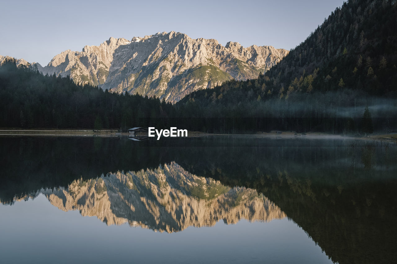 Reflection of mountains in lake against sky