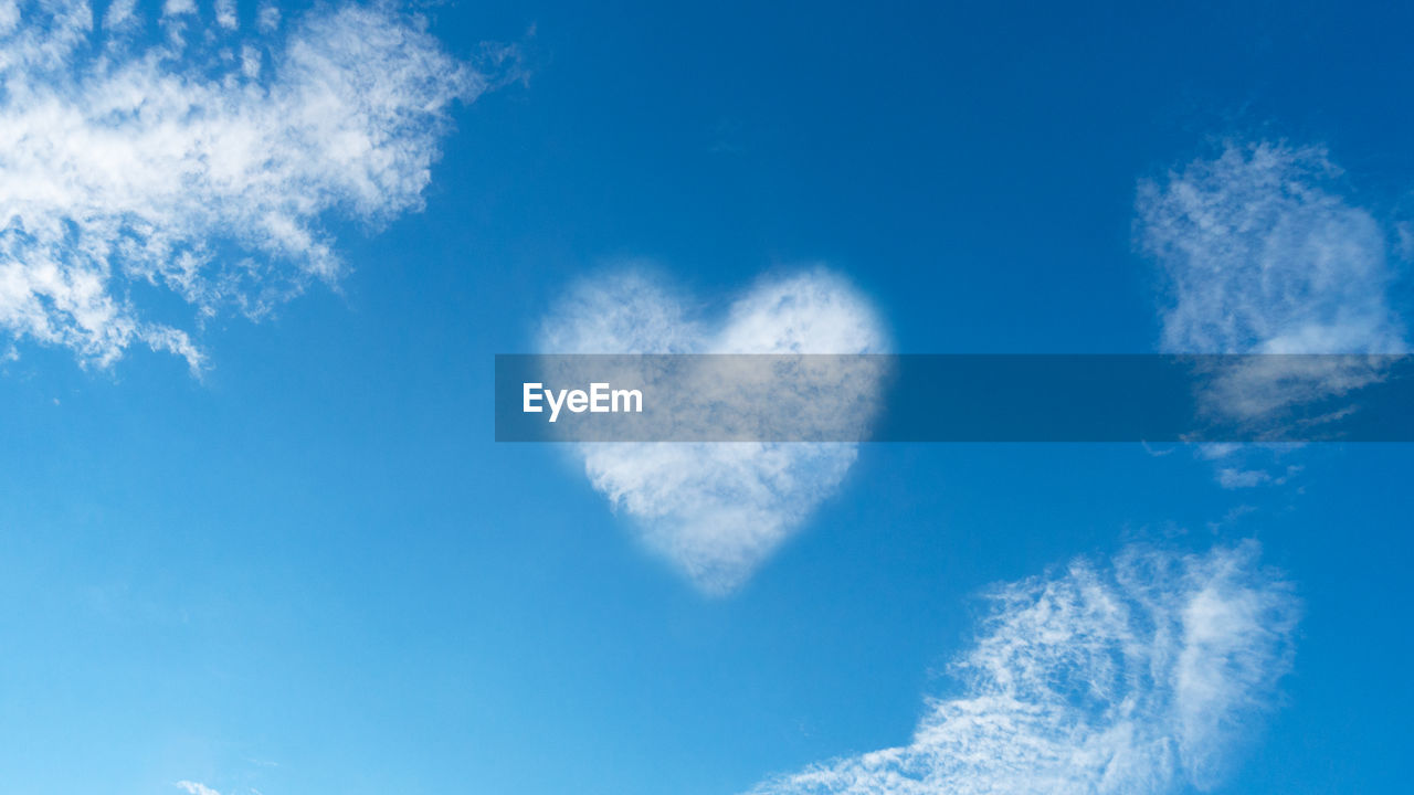 LOW ANGLE VIEW OF HEART SHAPE AGAINST SKY