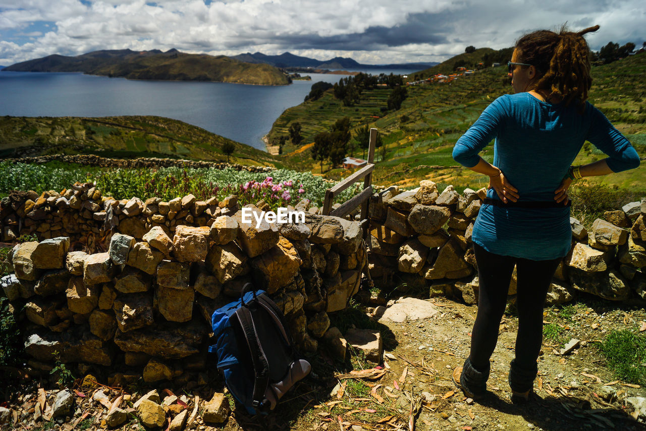 Rear view of woman standing on mountain