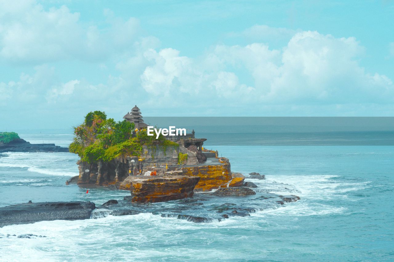 sea, water, ocean, land, sky, coast, shore, beach, nature, cloud, travel, scenics - nature, travel destinations, beauty in nature, bay, islet, cliff, rock, wave, vehicle, horizon over water, terrain, tourism, nautical vessel, history, environment, architecture, no people, outdoors, seascape, tropical climate, religion, coastline, the past, blue, motion, vacation, island, horizon, day, landscape, holiday, building, ship, trip, tree, tranquility, water sports, built structure