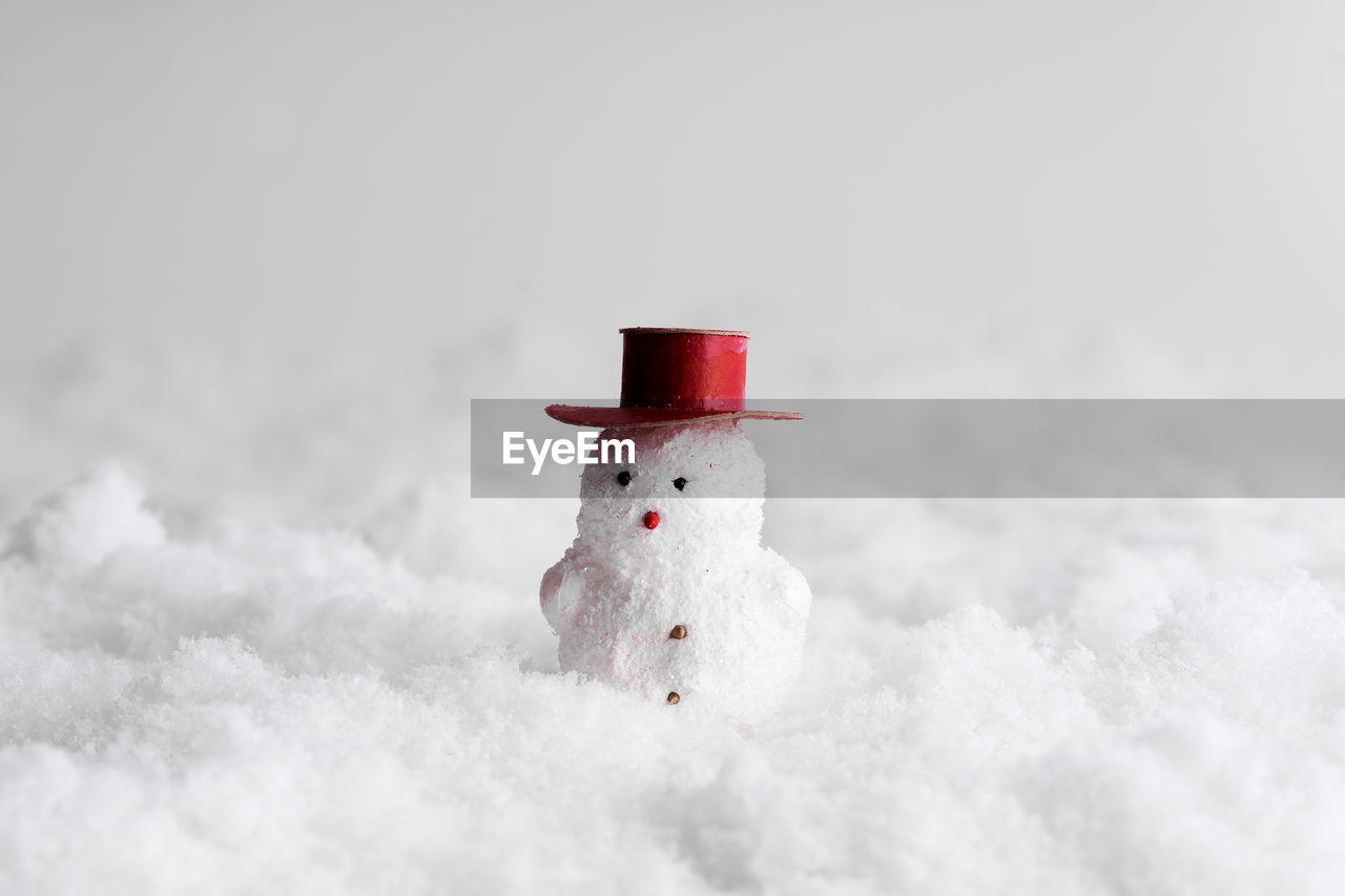 CLOSE-UP OF TOY ON SNOW AGAINST BLURRED BACKGROUND