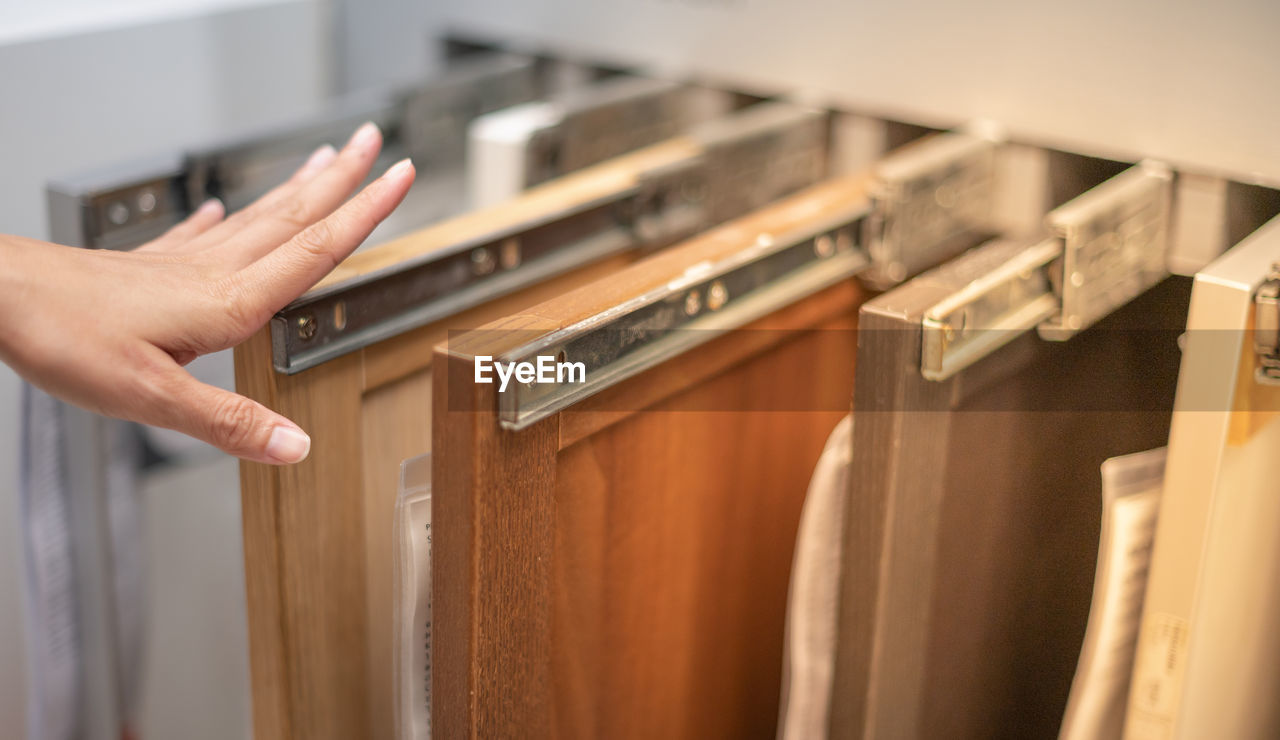 Female hand choosing the wood plate door for build in the interior doors inside the house.