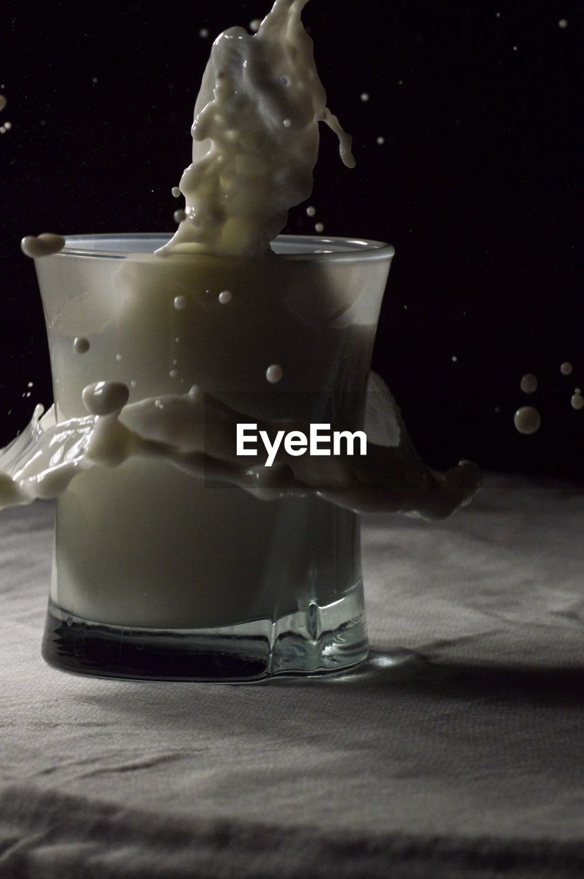 CLOSE-UP OF FOOD ON TABLE AGAINST BLACK BACKGROUND