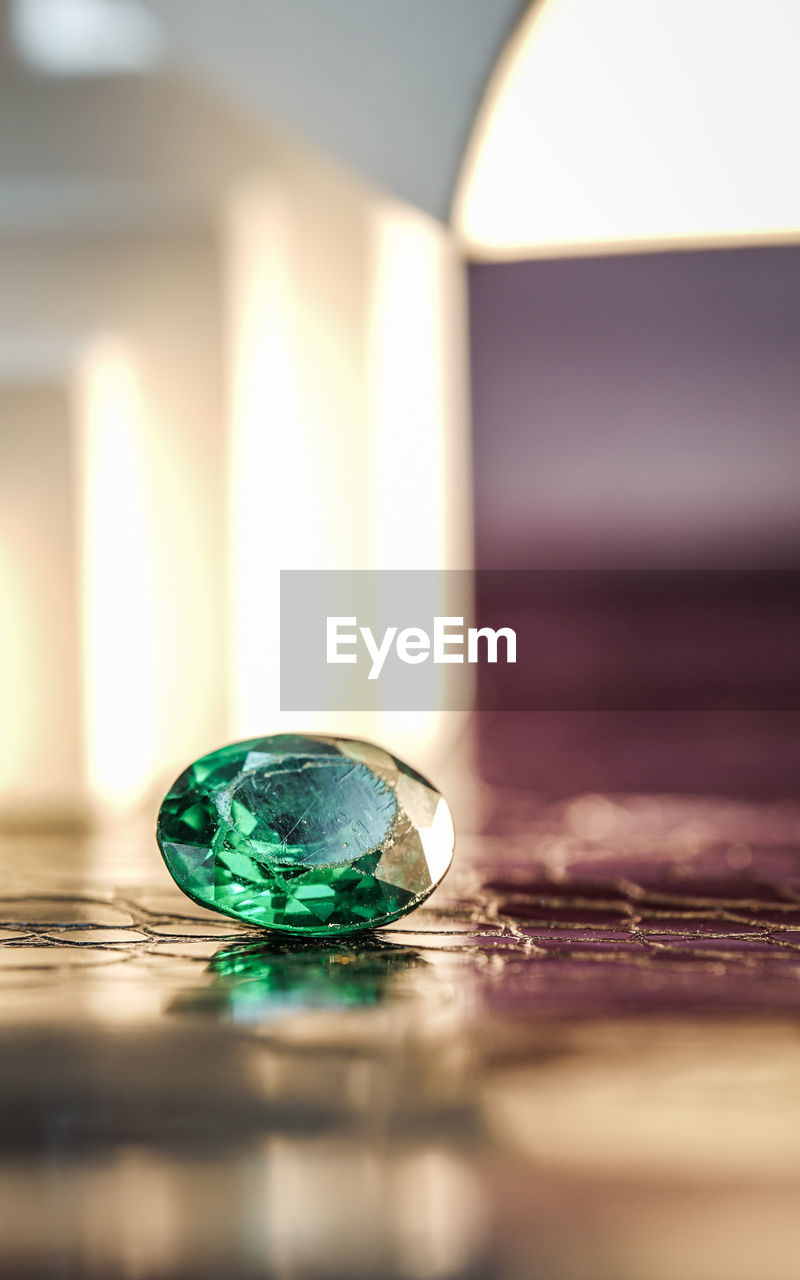 green, jewellery, indoors, selective focus, no people, close-up, glass, wealth, reflection, fashion accessory, gemstone, shiny, blue, macro photography, yellow, nature, lighting, table