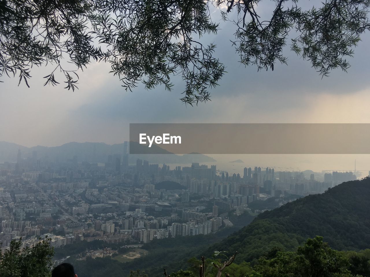 AERIAL VIEW OF CITY AND MOUNTAINS AGAINST SKY