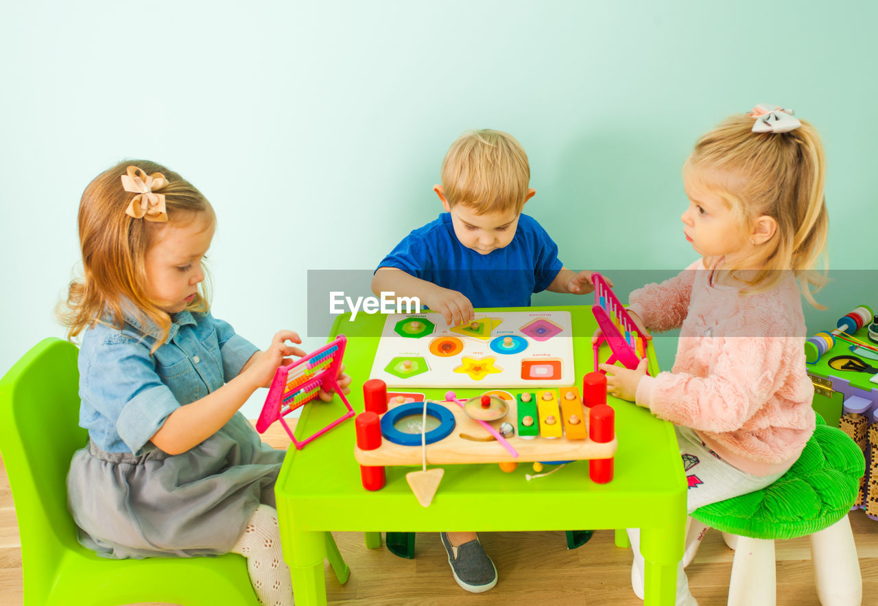 Bother and sisters playing at home