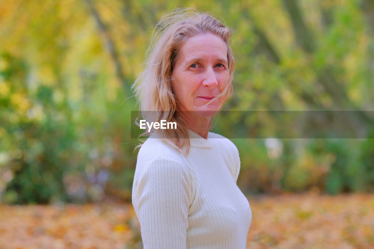 Portrait of smiling woman standing outdoors