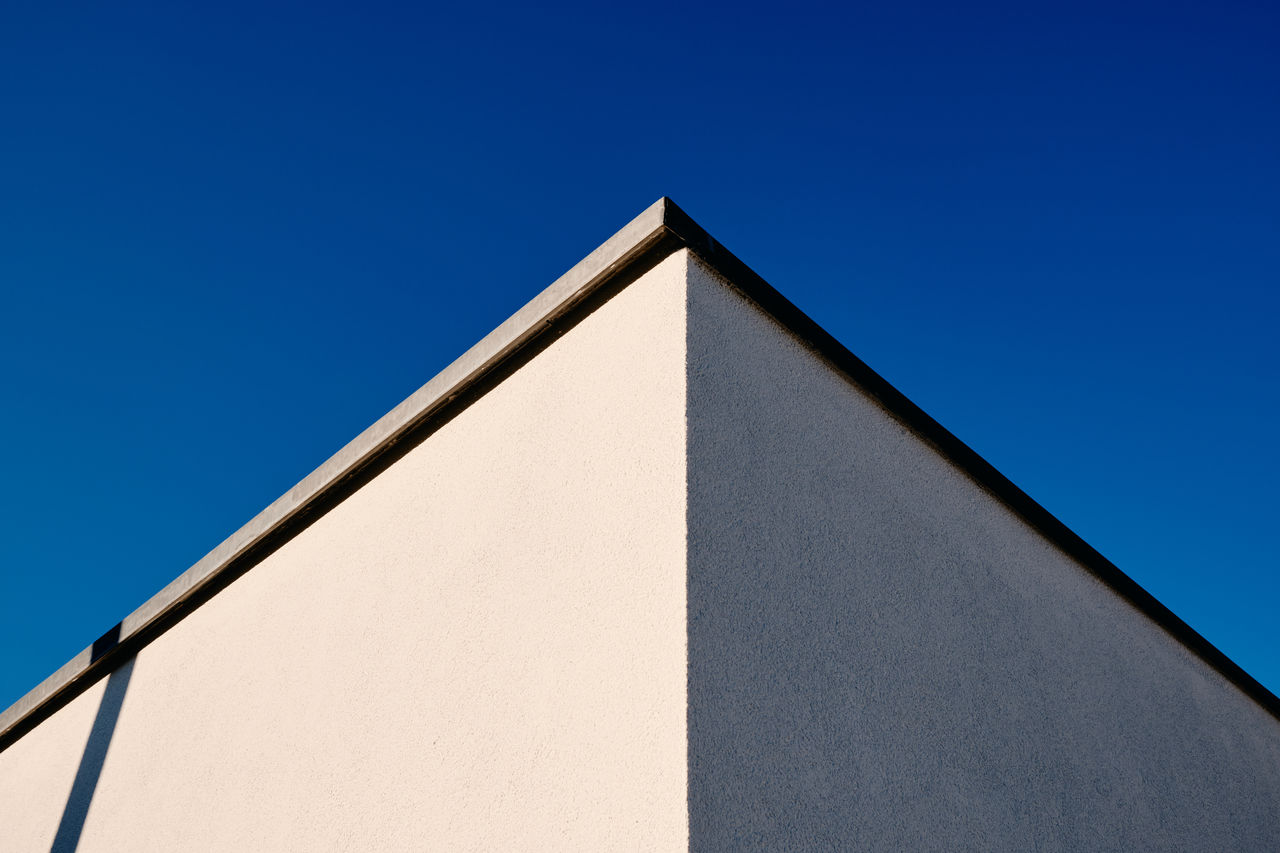 Low angle view of building against clear blue sky