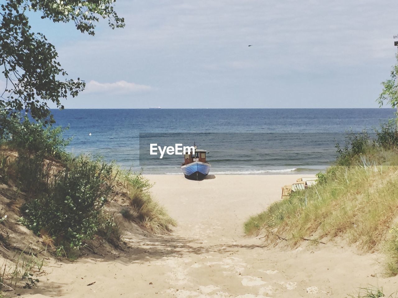 Boat at beach against sky