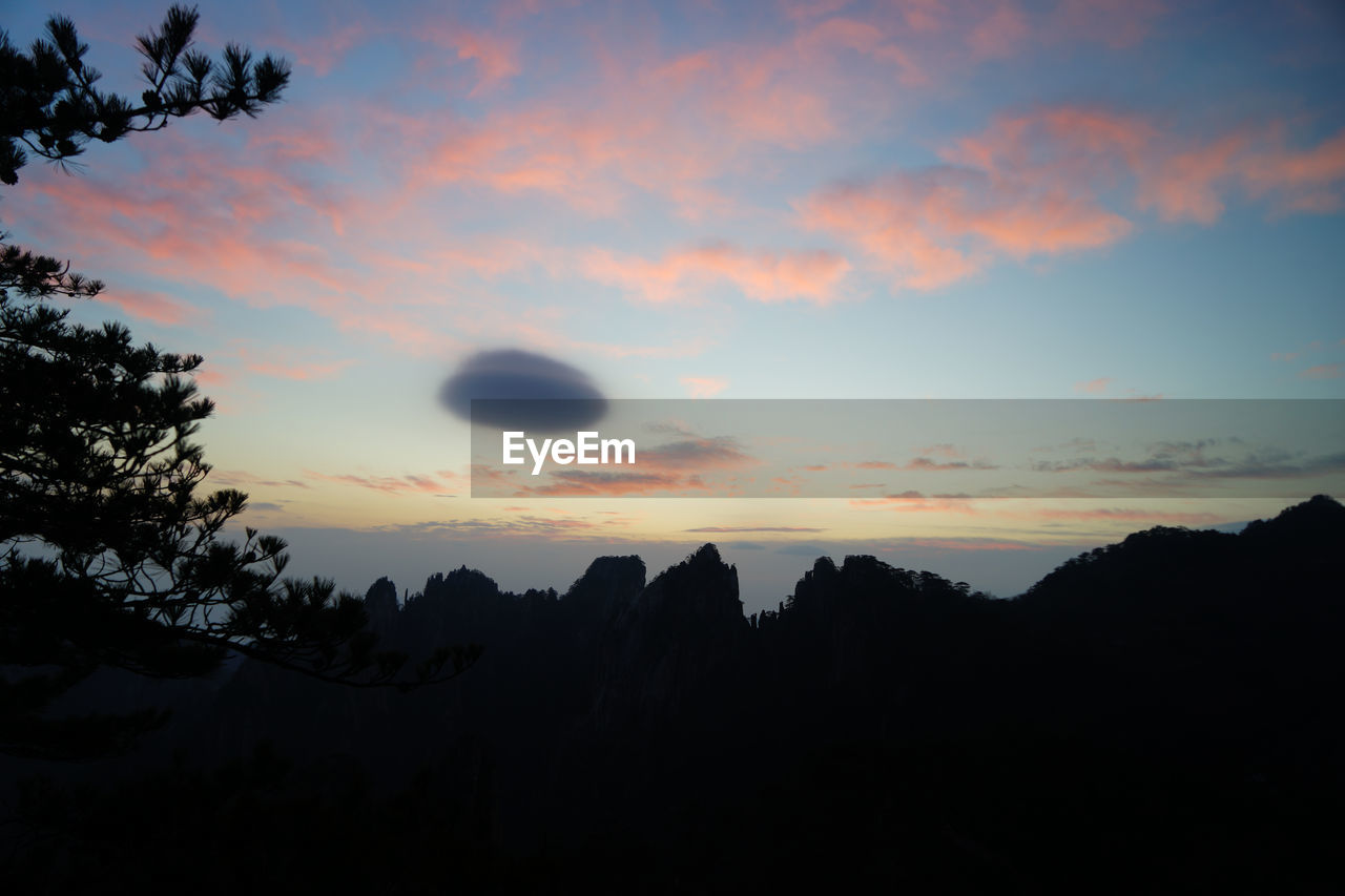 Silhouette landscape against scenic sky