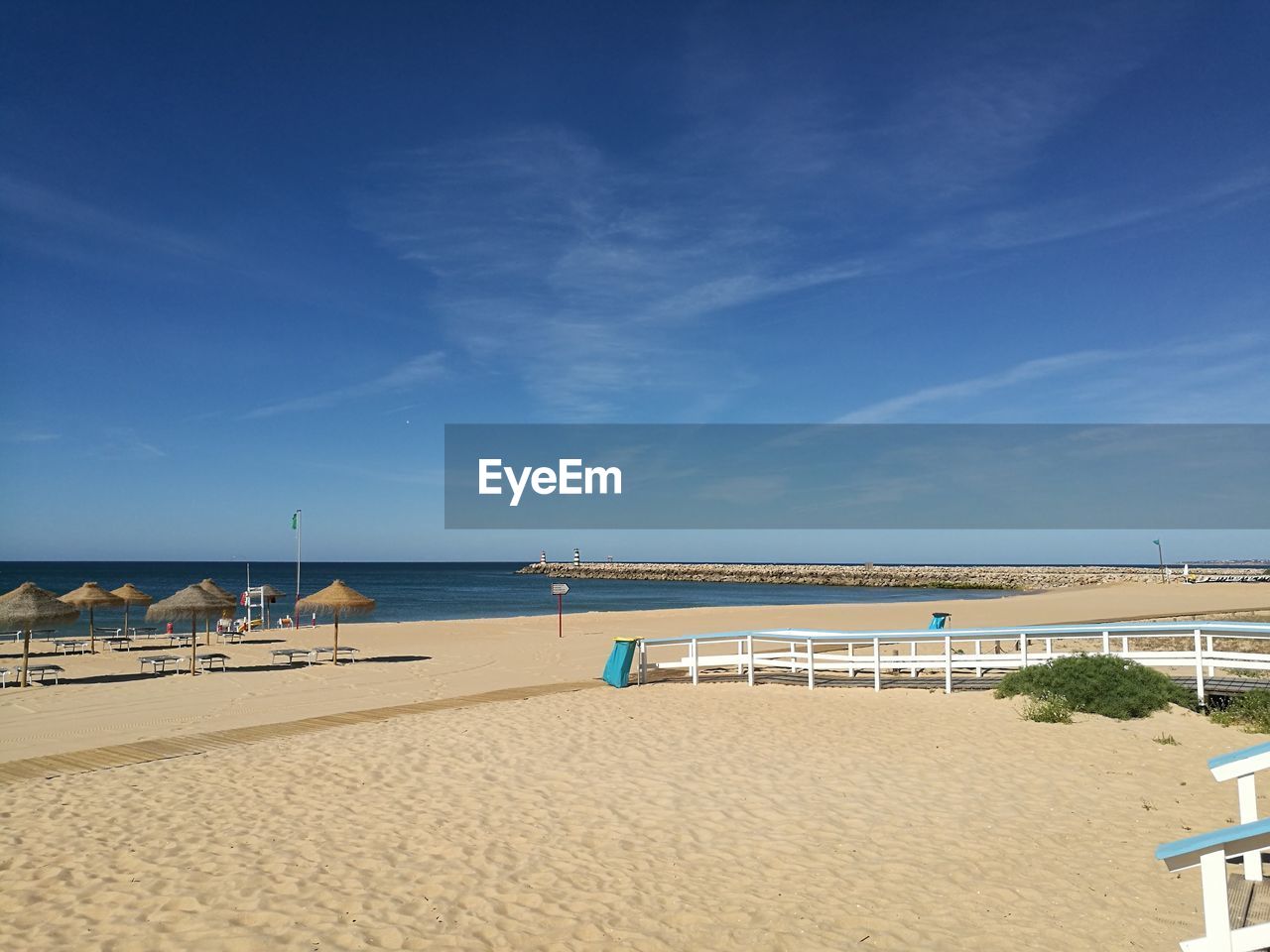 Scenic view of beach against blue sky