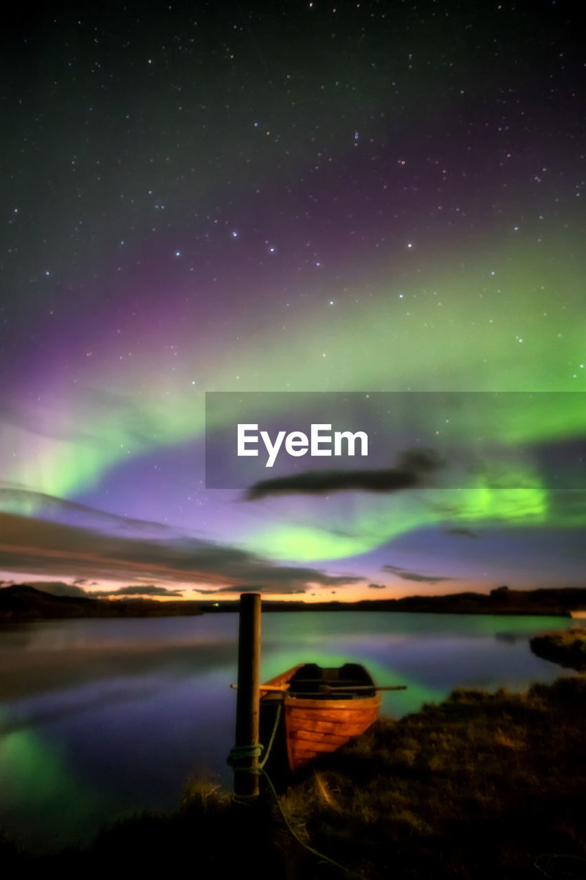 Scenic view of lake against sky at night