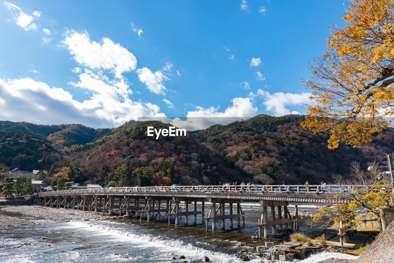 Bridge over mountain against sky during autumn