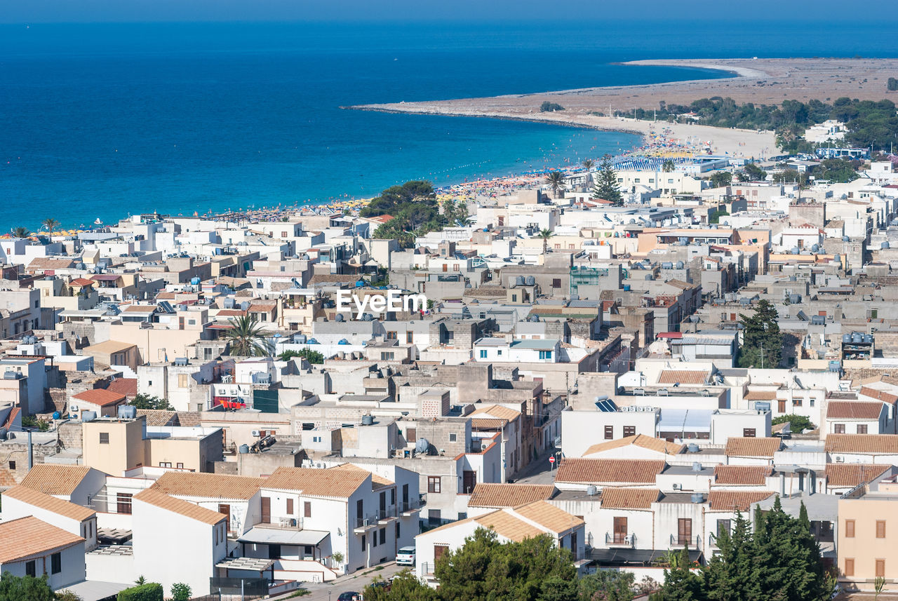 High angle view of townscape by sea