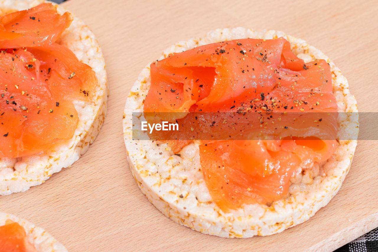 food and drink, food, salmon, freshness, healthy eating, wellbeing, dish, table, meal, indoors, cuisine, fish, no people, wood, close-up, egg, produce, serving size, still life, plate, seafood, bread, gourmet, breakfast, asian food, salmon-like fish, high angle view