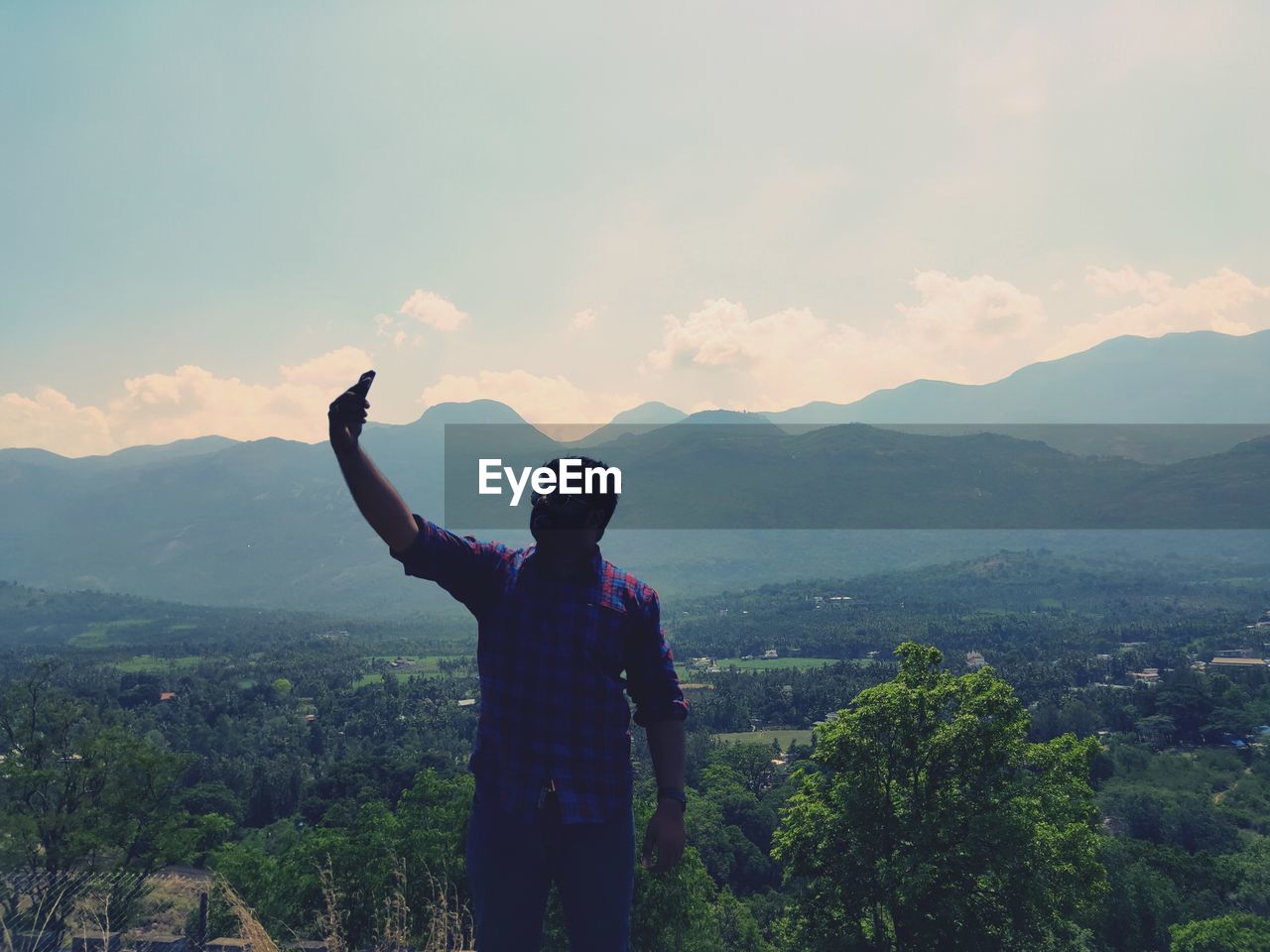 MAN LOOKING AT MOUNTAIN AGAINST SKY