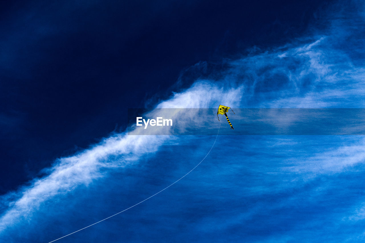 Low angle view of a kite flying in an ocean like sky