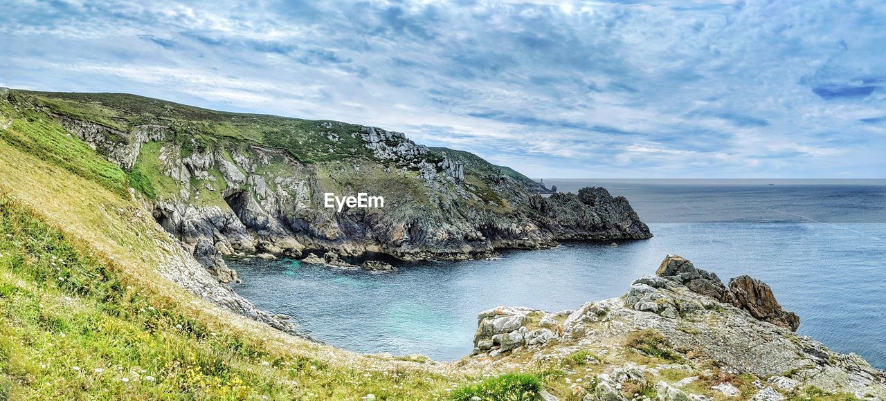 Rock formations in sea against sky