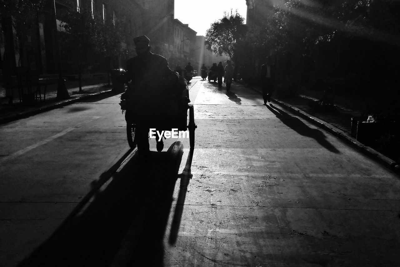 VIEW OF PEOPLE WALKING ON SIDEWALK